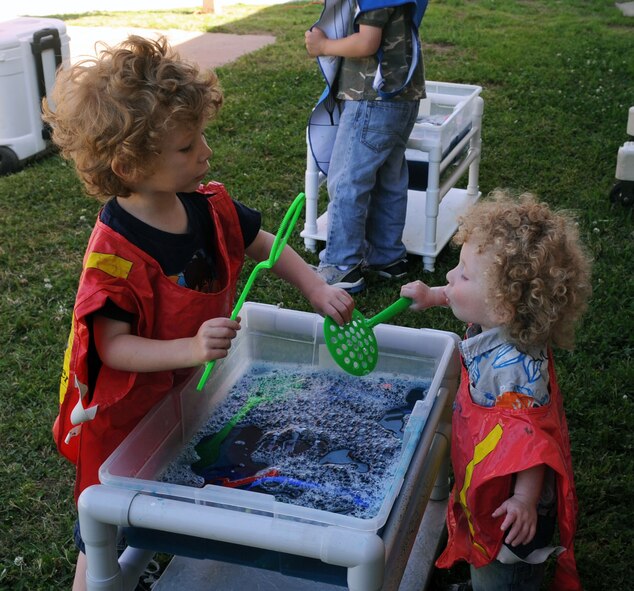 BARKSDALE AIR FORCE BASE, La. -- Peyton Gunter, 4, shows his baby brother Isaac, 2, how to blow bubbles during the Military Child Carnival held at the Barksdale Child Development Center here April 29. This event was held in support of the National Month of the Military Child. Peyton and Isaac are the sons of Tech. Sgt. Robert Gunter, 2d Aircraft Maintenance Squadron and Staff Sgt. Charita Gunter, 608th Air Communications Squadron. (U.S. Air Force photo by Senior Airman La’Shanette V. Garrett) (RELEASED)