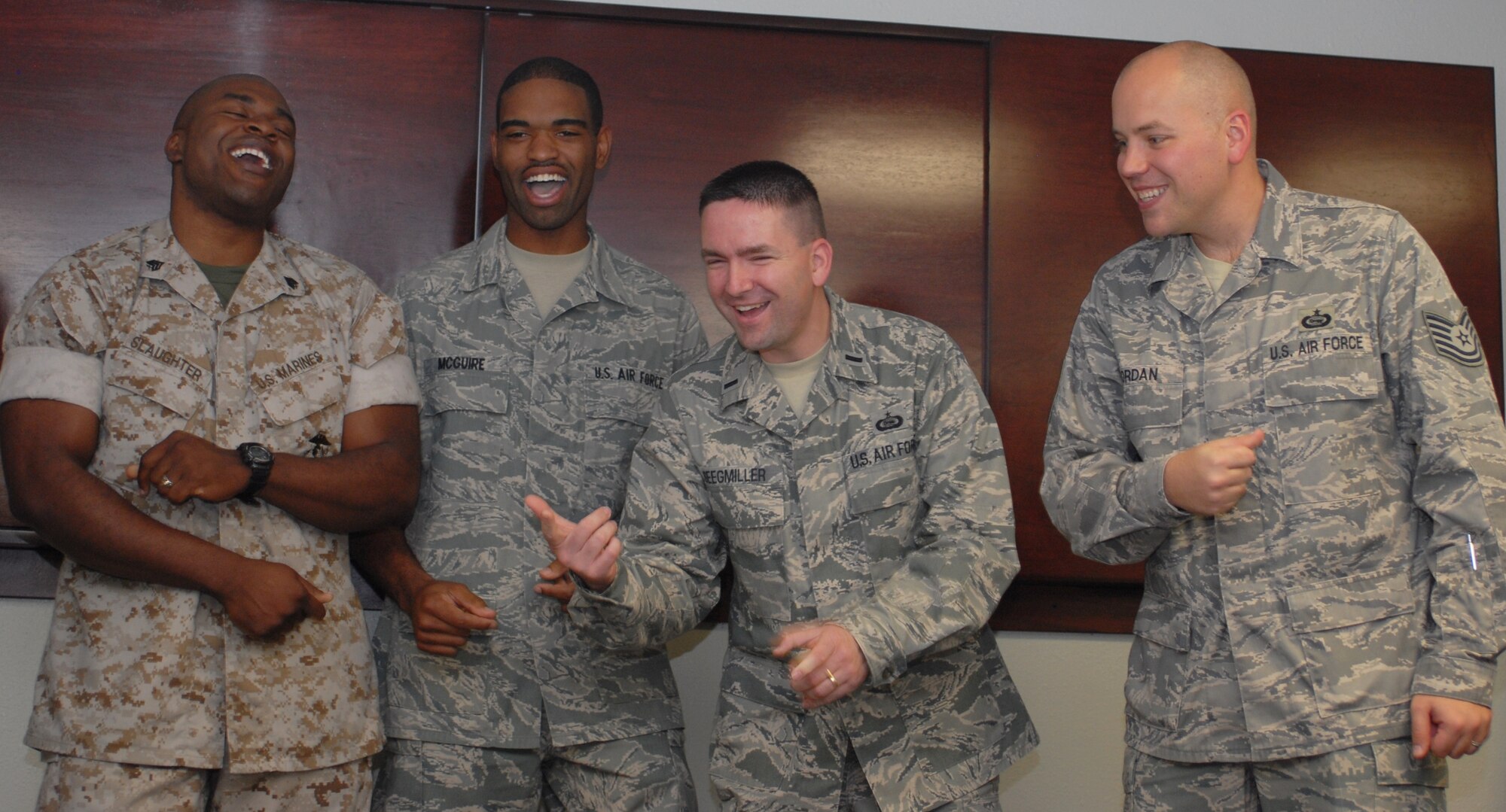 From left: Marine Sgt. Adam Slaughter, Marine Corps Detachment, Airman 1st Class Chadwick McGuire, 17th Training Support Squadron, 1st Lt Jared Seegmiller, 315th Training Squadron, and Tech. Sgt. Jason Jordan, 316th Training Squadron, loosen up at practice. Patriotic Blue volunteers meet once a week to make sure they're ready to sing at any performance whether a last minute request or something that's been scheduled weeks. (U.S. Air Force photo/Connie Hempel)