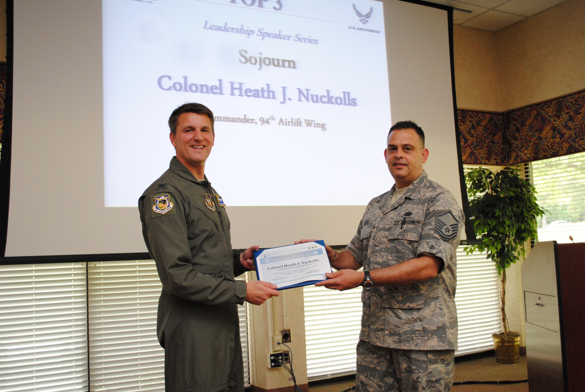 Col. Heath Nuckolls, 94th Airlift Wing commander, was presented a Top Three coin, a gift and a certificate of appreciation by Master Sgt. Larry Lopez, Dobbins Top 3 president, in appreciation for his service.  (U.S. Air Force photo/Master Sgt. Stan Coleman)