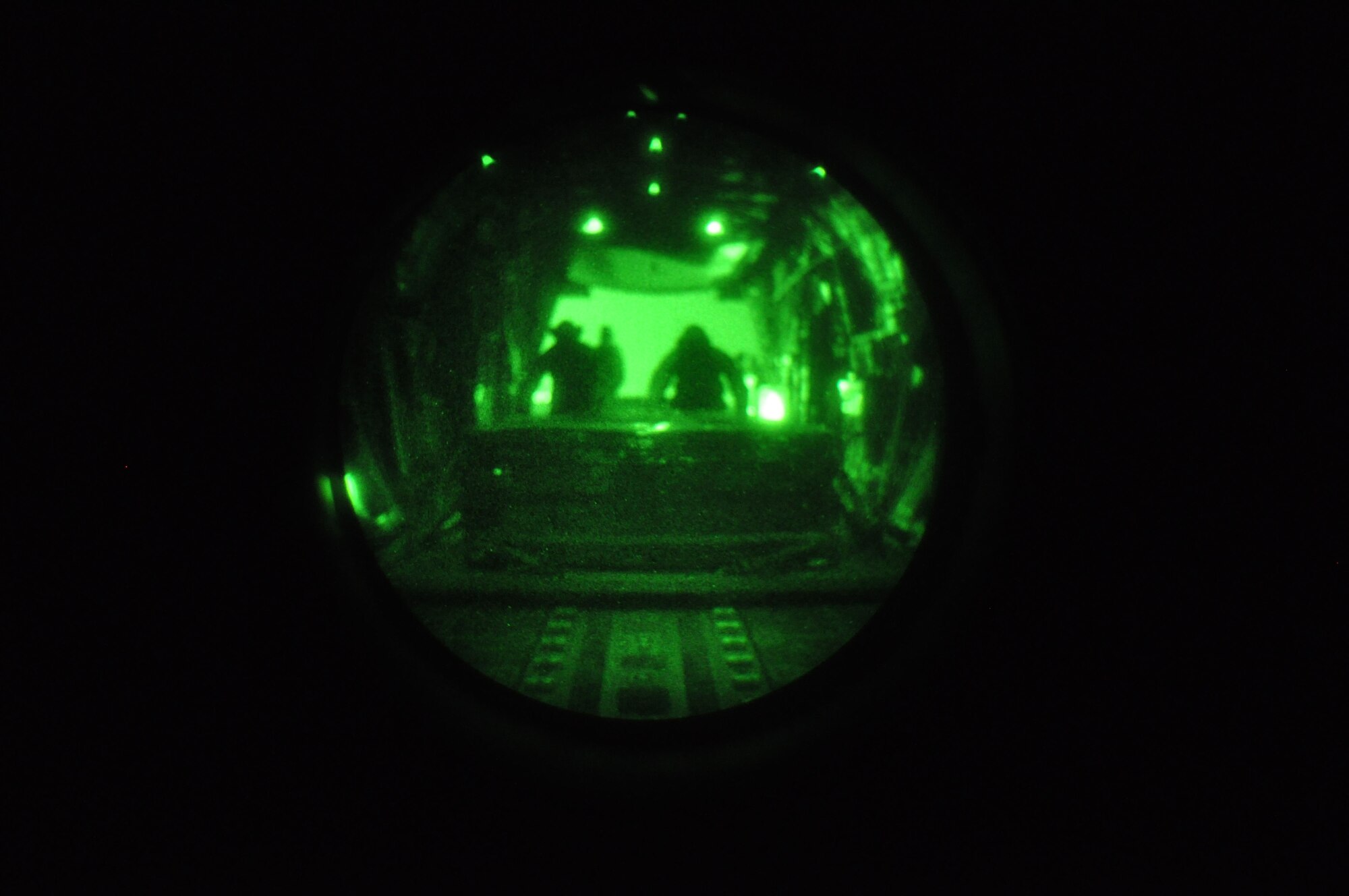Members of the 60th Aerial Port Squadron push a pallet in place during Phase III Night Vision Goggle training. (U.S. Air Force photo/Staff Sgt. Shaun Emery)