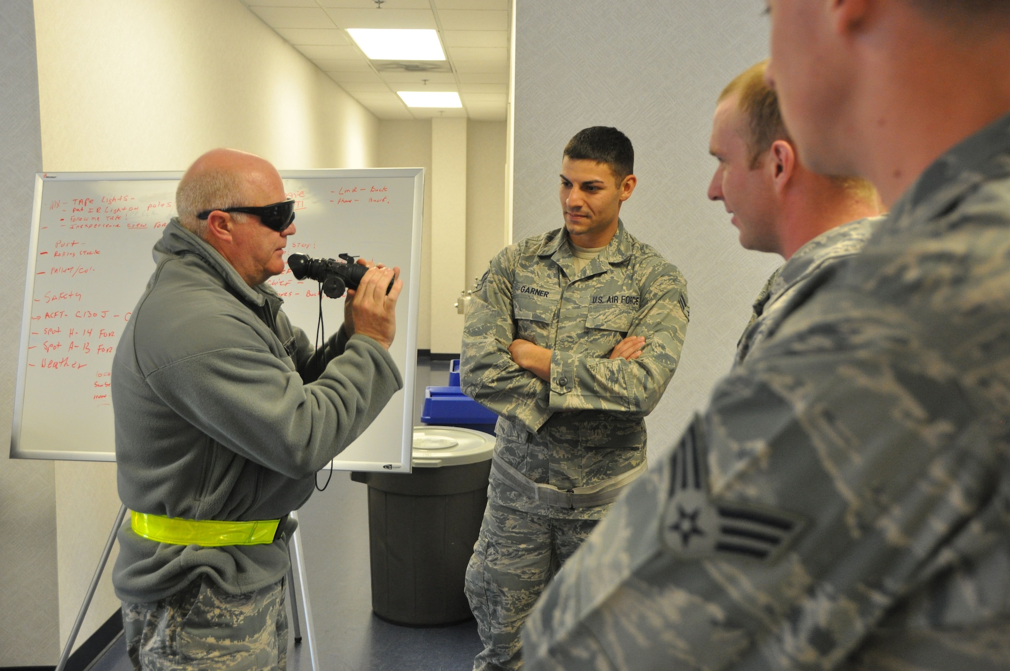 Buck Buchanan, 60th Aerial Port Squadron Ramp Operations flight chief, gives Phase III night vision goggle instruction to students prior to conducting training on the flight line. (U.S. Air Force photo/Staff Sgt. Shaun Emery)