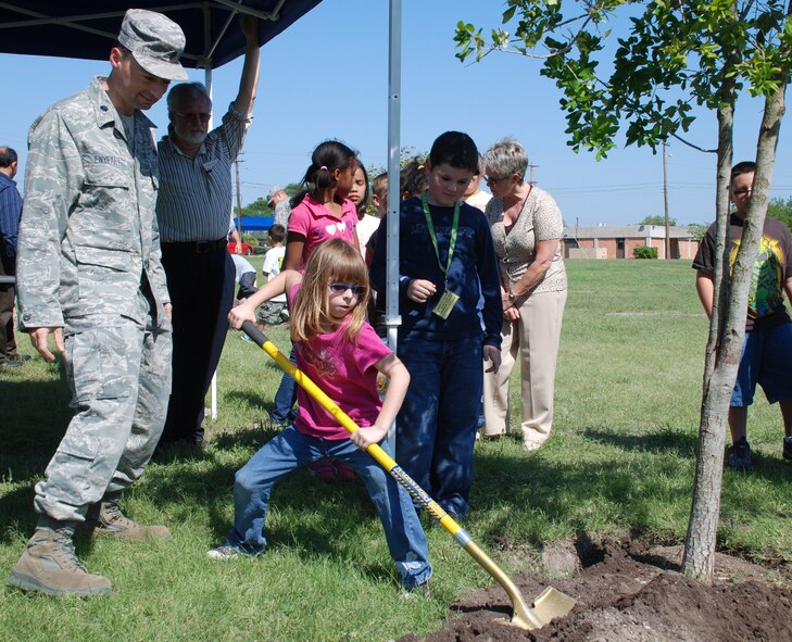 LAUGHLIN AIR FORCE BASE, Texas – Mackenzie Chapman, of Laughlin’s youth center, helps plant a tree as Lt. Col. John Enyeart, 47th Installation Support Squadron commander, looks on during Arbor Day festivities here April 30. Arbor Day, which originated in the United States in 1872, is a day when people are encouraged to plant and care for trees. For the past 16 years, Laughlin has been recognized as being a Tree City. To be considered a Tree City, a community must have a tree department, a tree-care ordinance, a forestry program and an Arbor Day observance and proclamation. (U.S. Air Force photo by Airman 1st Class Blake Mize)