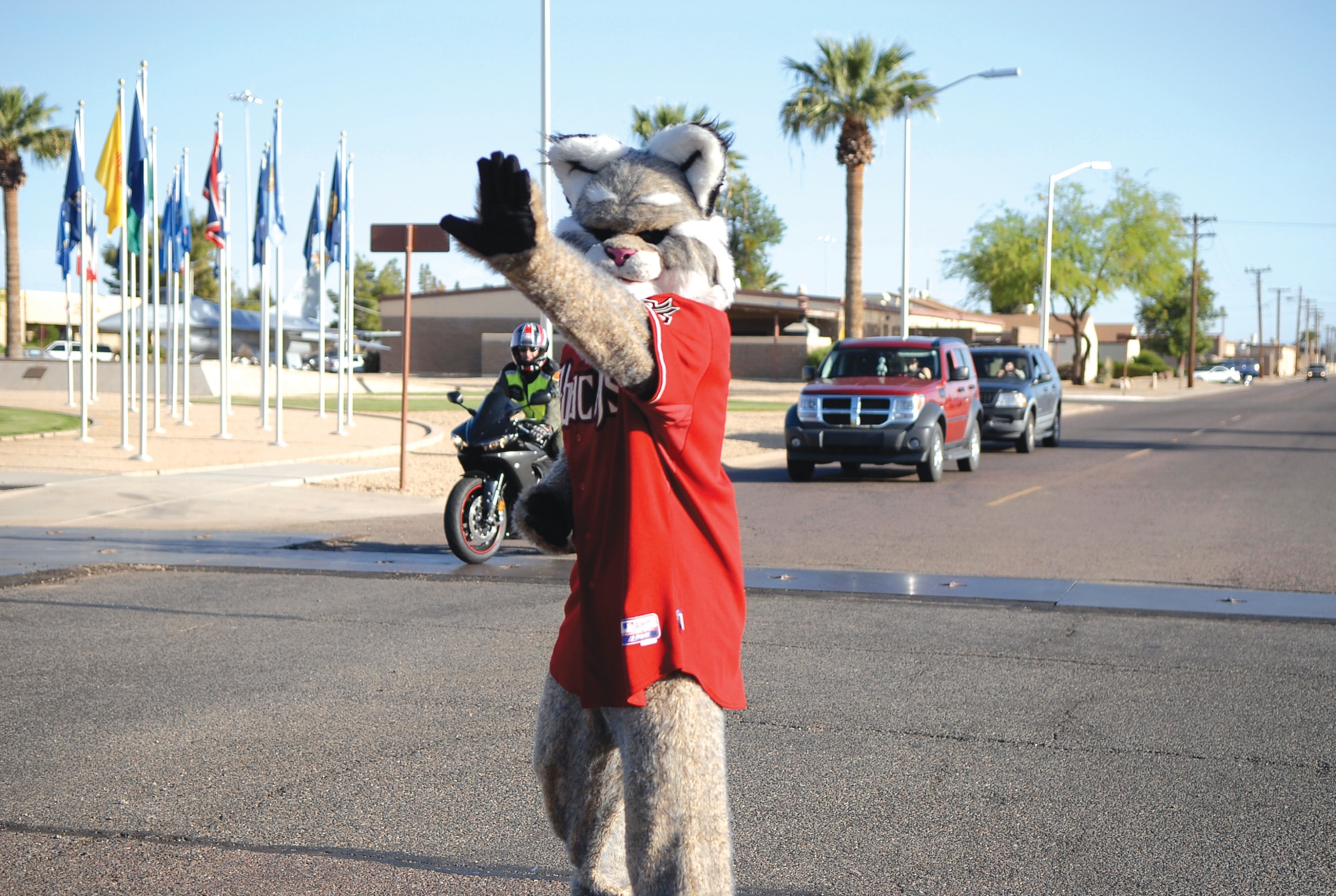 Baxter the Bobcat directs traffic for unsuspecting Luke drivers April 27 near the wing headquarters. (U.S. Air Force photo by Airman 1st Class Ronifel Yasay)