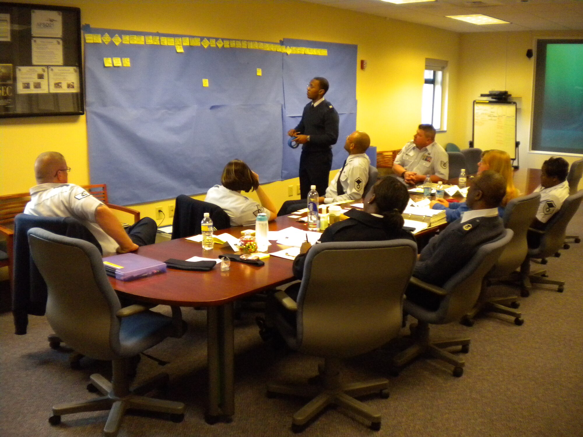 Capt. Wayne Leneau, Process Manager with the 315th Airlfit Wing, Charleston Air Force Base S.C. leads a team of voulenteers in an attempt to ease the process of recieving health care when a spouse is deployed. The team of eight reservists and two civilians met over five days coming up with solutions to the problems with the Tricare system for families. (U.S. Air Force Photo)