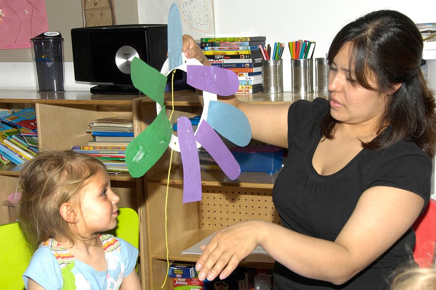 HANSCOM AIR FORCE BASE, Mass. - Ashley Goglia (left) and Jessica Franklin work on an arts and crafts project. Mrs. Franklin, a Family Child Care provider, takes care of six children in her home. (U.S. Air Force photo by Linda LaBonte Britt)