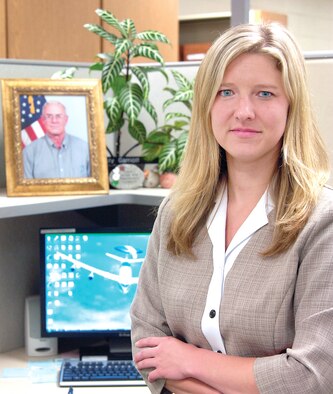 A picture of her father, Kris, adorns Kristy Garriott’s workspace. The E-3 engineer with the 327th Aircraft Sustainment Wing, is working at Tinker in the same type of position that her father held for years.(Air Force photo by Margo Wright)

