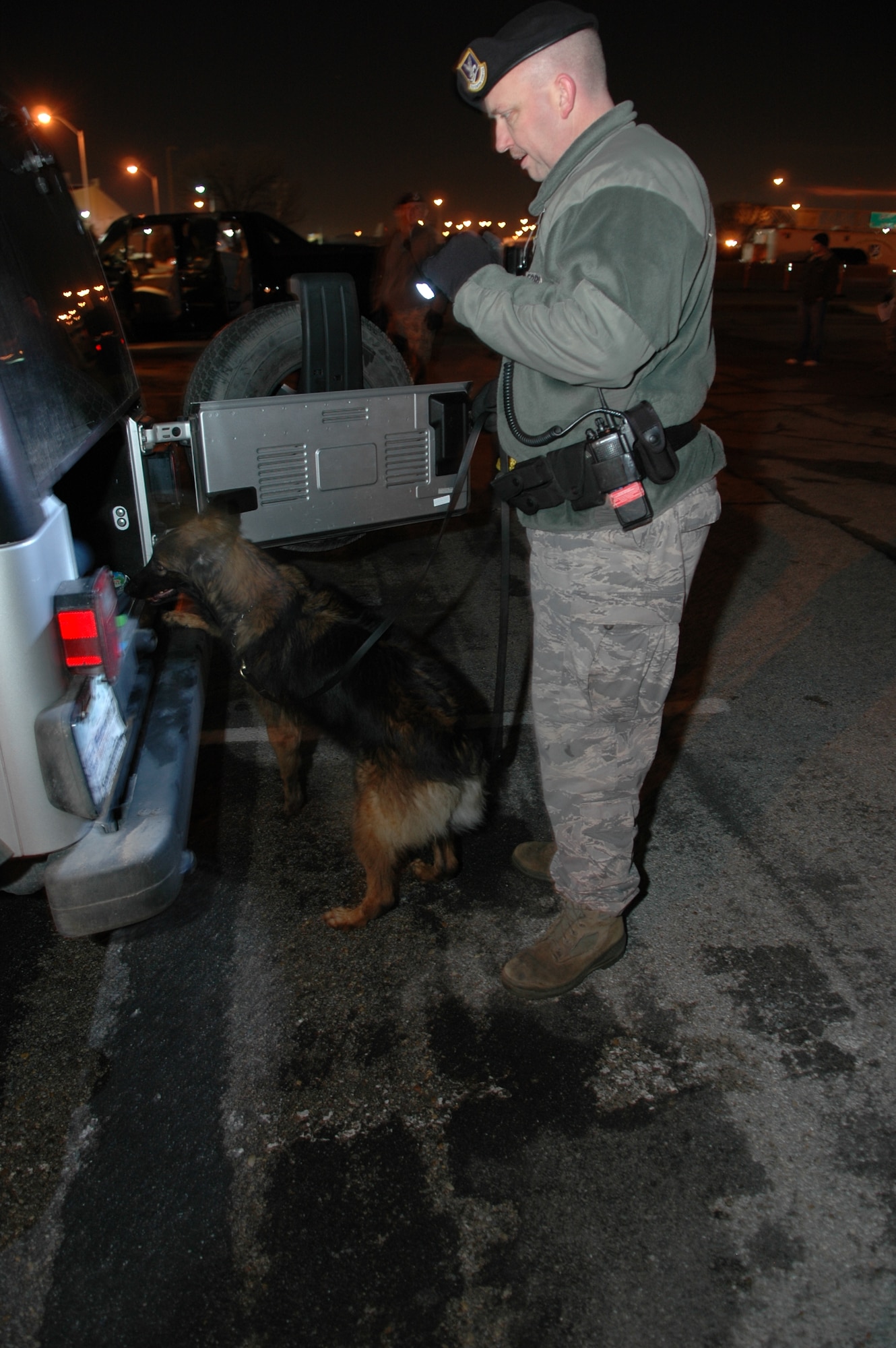 72nd Security Forces Squadron Military Working Dog, Cita, and her handler, Tech. Sgt. John Ater, searched more than 30 vehicles during a recent screening at one of Tinker’s gates. The squadron’s MWD teams recently participated in training where they were recognized as some of the best.  (Air Force photo by Micah Garbarino)
