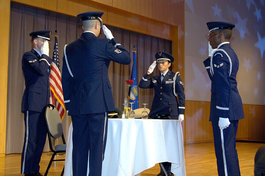 The Tinker Honor Guard performs a solemn POW/MIA table ceremony during a recent Tinker event at the National Cowboy and Western Heritage Museum in Oklahoma City.  Members represent the Air Force, and Tinker, as they honor military members at funerals and care for the flags during numerous events on base and in the community. Pictured clockwise from front are, Staff Sgt. Lawrence Bach, Airman 1st Class Benjamin Powe, Senior Airman Jennifer Stacy and Airman 1st Class Johnathan Flemmer. (Air Force photo by Margo Wright)
