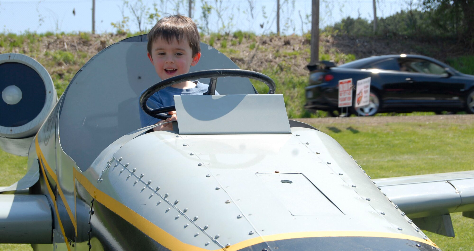 Aiden O’Neill, 4, has a good time “flying” the mini A-10 during the 2010 New England Chili Cook-Off at Pleasant View Farms, Somers, Conn. May 1, 2010. Aiden and his parents were but a few of the 3,500 people that attended the all-day event contributing to the $18,000 dollars to be split between the Connecticut Patriot Guard Riders and the Somers Fire Department. (U.S. Air Force photo by Tech. Sgt. Joshua Mead)