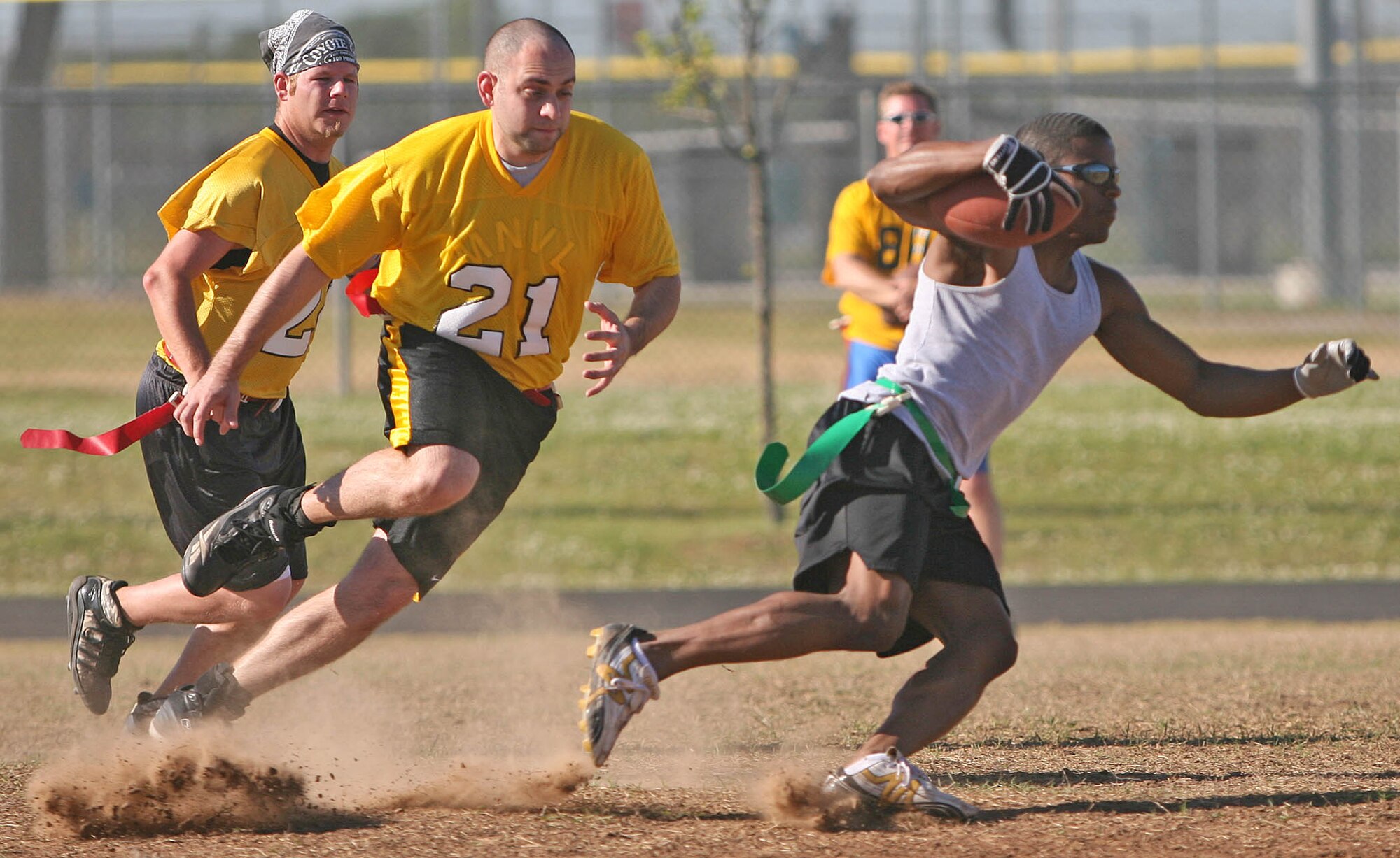 VQ-7 receiver Joe Collins runs downfield for a first down in the face of a Reserve Gold safety May 4. It was a narrow victory for fourth-seeded VQ-7, but a victory all the same as they beat the fifth-seeded Reserve Gold 6-0.(Air Force photo by John Stuart)
