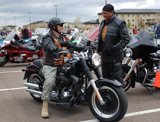 Col. Gregory Rosenmerkel, 819th RED HORSE Squadron commander, stops to chat with one of his staff members, Staff Sgt. Jason Joseph, when arriving at the motorcycle safety day. (U.S. Air Force photo/Valerie Mullett)