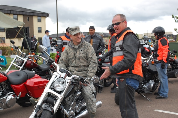 Master Sgt. David Haight, 819th RED HORSE Squaron, chats with Col. Michael Fortney, 341st Missile Wing commander, at the start of the annual Rolling Thunder Motorcycle Safety event April 23. (U.S. Air Force photo/Valerie Mullett)