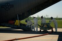 KILN, Miss. -- A team of Air Force Reserve aerial spray aircraft maintainers assigned to the 910th Aircraft Maintenance Squadron at Youngstown Air Reserve Station, Ohio, refill a chemical dispersing C-130 Hercules cargo aircraft at Stennis International Airport here, May 4. Members of the 910th Airlift Wing (AW) are in Mississippi to assist with response to the Deepwater Horizon oil spill. The 910th AW specializes in aerial spray and is the Department of Defense?s only large-area, fixed-wing aerial spray unit. U.S. Air Force photo by Tech. Sgt. Adrian Cadiz/Released.