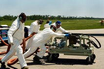 KILN, Miss. -- A team of Air Force Reserve aerial spray aircraft maintainers, assigned to the 910th Aircraft Maintenance Squadron based at Youngstown Air Reserve Station, Ohio, move a chemical pump into position to refill a chemical dispersing C-130 Hercules cargo aircraft at Stennis International Airport here, on May 4. Members of the 910th Airlift Wing are in Mississippi to assist with response to the Deepwater Horizon oil spill. The 910th AW specializes in aerial spray and is the Department of Defense?s only large-area, fixed-wing aerial spray unit. U.S. Air Force photo by Tech. Sgt. Adrian Cadiz/Released.