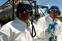 KILN, Miss. -- A team of Air Force Reserve aerial spray aircraft maintainers, assigned to the 910th Aircraft Maintenance Squadron based at Youngstown Air Reserve Station, Ohio, prepare to refill a chemical dispersing C-130 Hercules cargo aircraft at Stennis International Airport here, May 4. Members of the 910th Airlift Wing (AW) are in Mississippi to assist with response to the Deepwater Horizon oil spill. The 910th AW specializes in aerial spray and is the Department of Defense?s only large-area, fixed-wing aerial spray unit. U.S. Air Force photo by Tech. Sgt. Adrian Cadiz/Released.