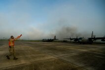 KILN, Miss. -- Air Force Reserve Tech. Sgt. Jim Graves, assigned to the 910th Aircraft Maintenance Squadron based at Youngstown Air Reserve Station, Ohio, marshals a chemical-dispersing C-130 Hercules cargo aircraft into a prepositioned parking spot at Stennis International Airport here, May 4. Members of the 910th Airlift Wing (AW) are in Mississippi to assist with response to the Deepwater Horizon oil spill. The 910th AW specializes in aerial spray and is the Department of Defense?s only large-area, fixed-wing aerial spray unit. U.S. Air Force photo by Tech. Sgt. Adrian Cadiz/Released.