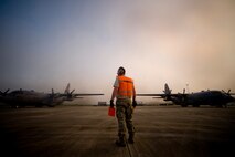KILN, Miss. -- Air Force Reserve Tech. Sgt. Joe Torba, assigned to the 910th Aircraft Maintenance Squadron based at Youngstown Air Reserve Station, Ohio, prepares to marshal a chemical-dispersing C-130 Hercules cargo aircraft into a prepositioned parking spot at Stennis International Airport here, May 4. Members of the 910th Airlift Wing (AW) are in Mississippi to assist with response to the Deepwater Horizon oil spill. The 910th AW specializes in aerial spray and is the Department of Defense?s only large-area, fixed-wing aerial spray unit. U.S. Air Force photo by Tech. Sgt. Adrian Cadiz/Released.