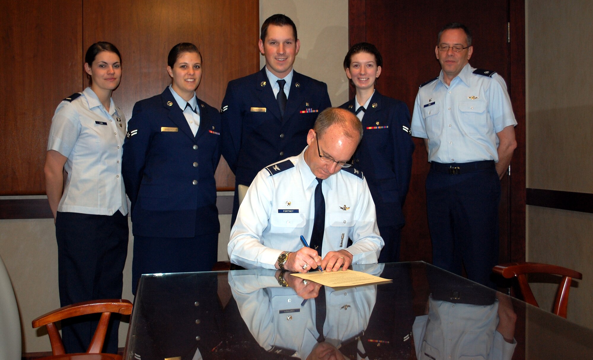 Members of the 341st Medical Operations Squadron watch as Col. Michael Fortney, 341st Missile Wing commander, signs the National Nurse and Technician Appreciation Week Proclamation, which will be celebrated May 6-12. Pictured left to right from the clinic are 1st Lt. Angela Ling, Airman 1st Class Jocelyn Frenyea, Airman 1st Class Zachary Freeman, Airman 1st Class Alexis Rann and 341st MDOS Commander Lt. Col. Dale Grey. (U.S. Air Force photo/Valerie Mullett)