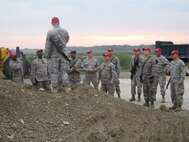 Master Sgt. Grady Raynor, 567th Red Horse Squadron, gives reservists from the airfield shop instructions on crater repair. (USAF photo courtesy of 567 RHS)