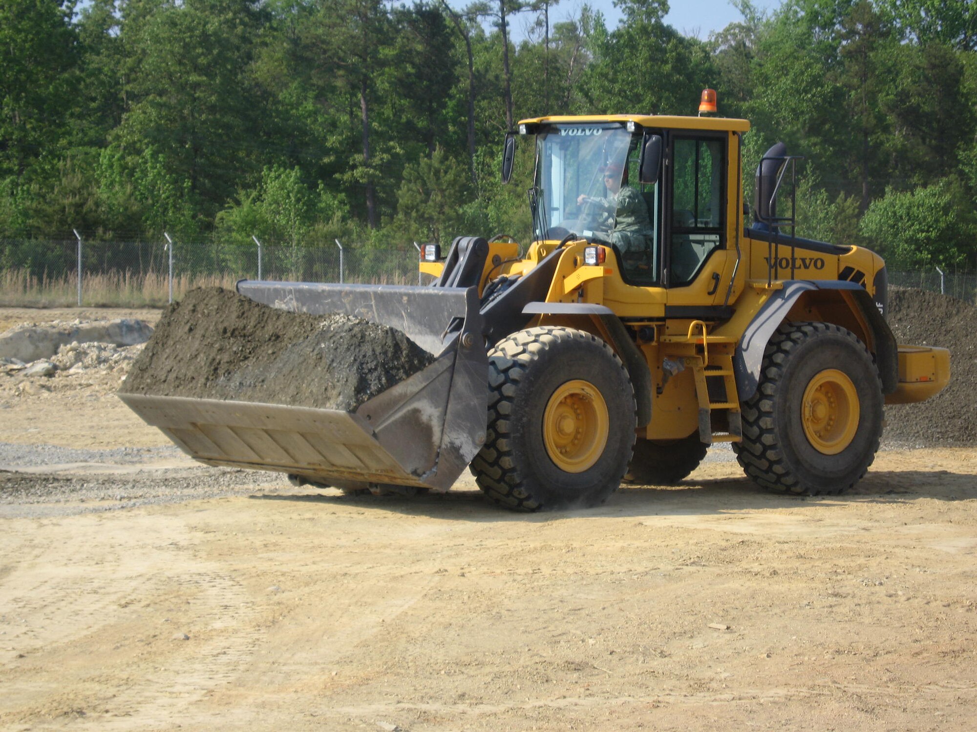 A bulldozer from the airfield shop of the 567th Red Horse Squadron prepares ground for the erection of a tent city. (USAF photo courtesy of 567 RHS)