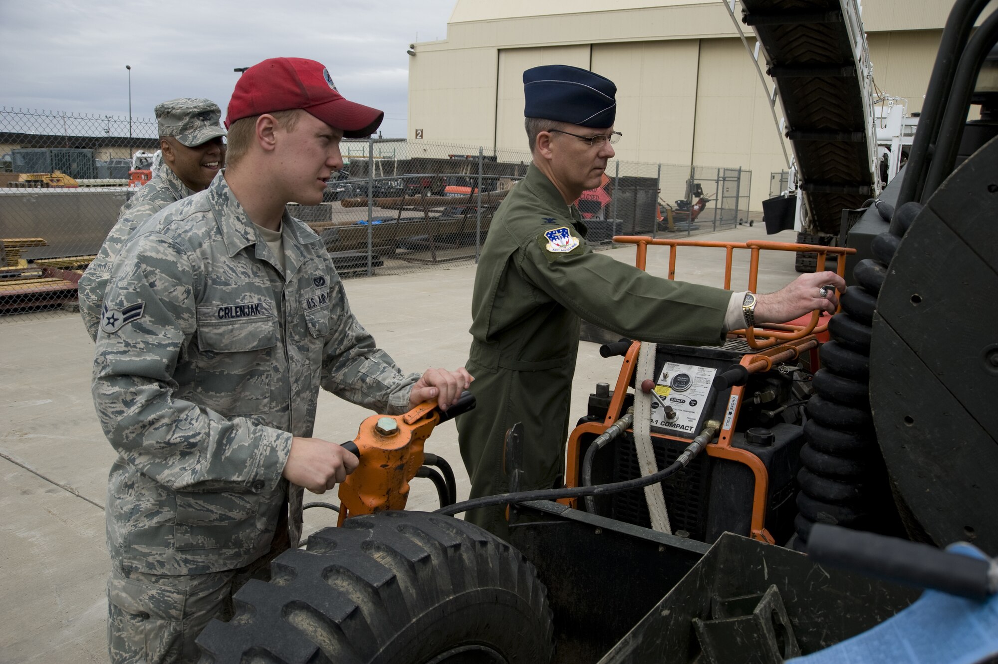 Airman 1st Class Alex Crlenjak, an electrical power production apprentice with the 819th RED HORSE Squadron, explains the control side of a monile aircraft arreting system to 341st Missile Wing Commander Col. Michael Fortney. Col. Anthony Cotton, 341st MW vice commander looks on. (U.S. Air Force photo/Beau Wade)