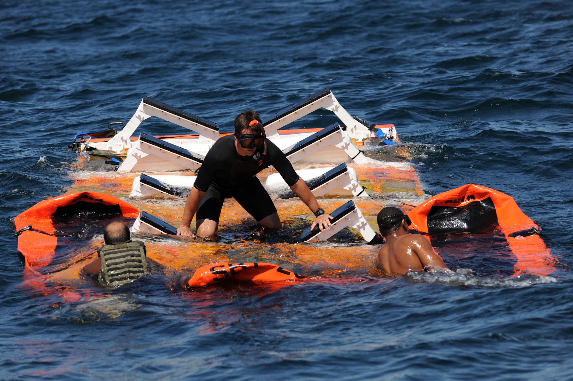 U.S. Navy Special Warfare boat operators from Special Boat Team 20 secure the platform in the Gulf of Mexico April 26, 2010. The platform held an inflatable boat from SBT-20, home-ported at Joint Expeditionary Base Little Creek, Va., and was dropped into the ocean by an MC-130H assigned to the 15th Special Operations Squadron at Hurlburt Field, Fla., as part of joint training conducted by the maritime training division of the 1st Special Operations Support Squadron Range Support Flight from Hurlburt Field. (DoD photo by U.S. Air Force Senior Airman Matthew Loken)