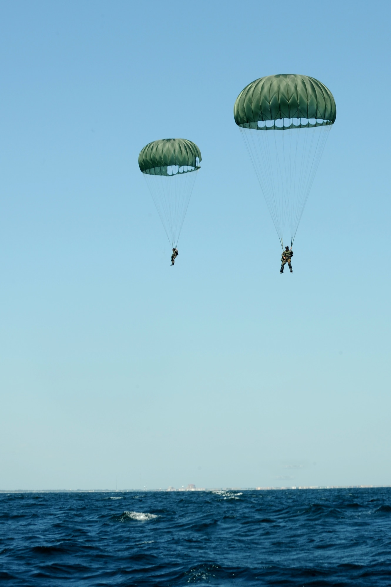 A pair of Sailors from U.S. Navy Special Boat Team 20 parachute down to the Gulf of Mexico April 26, 2010 after jumping out of an MC-130H assigned to the 15th Special Operations Squadron at Hurlburt Field. Fla. SBT-20, home-ported at Joint Expeditionary Base Little Creek, Va., and the 15th SOS participated in joint training conducted by the maritime training division of the 1st Special Operations Support Squadron Range Support Flight from Hurlburt Field. (DoD photo by U.S. Air Force Airman Caitlin O'Neil-McKeown)