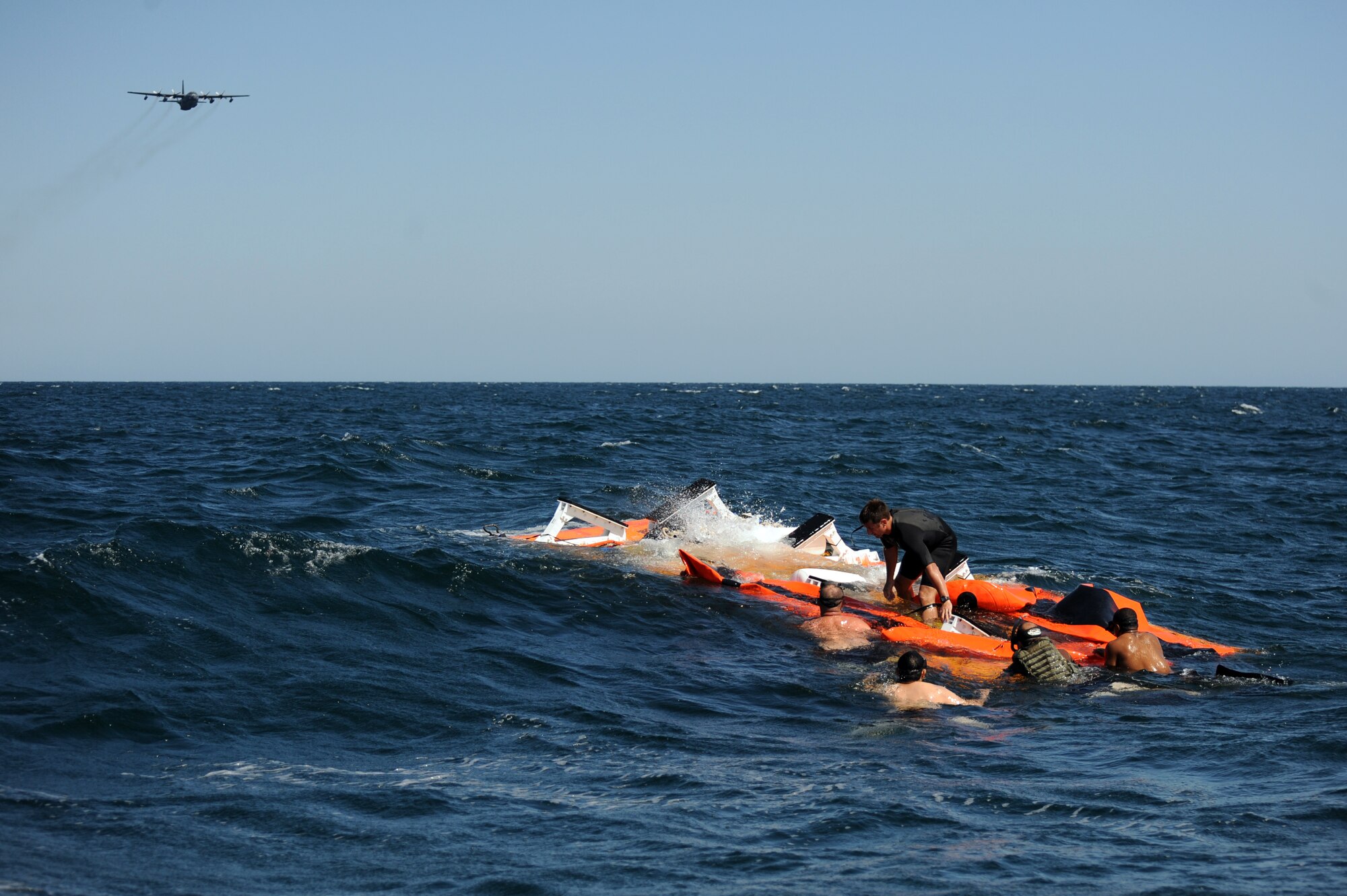 U.S. Navy Special Warfare boat operators from Special Boat Team 20 secure a platform as an MC-130H assigned to the 15th Special Operations Squadron at Hurlburt Field, Fla., makes a pass over the Gulf of Mexico April 26, 2010. SBT-20, home-ported at Joint Expeditionary Base Little Creek, Va., and the 15th SOS participated in joint training conducted by the maritime training division of the 1st Special Operations Support Squadron Range Support Flight from Hurlburt Field. (DoD photo by U.S. Air Force Senior Airman Matthew Loken)