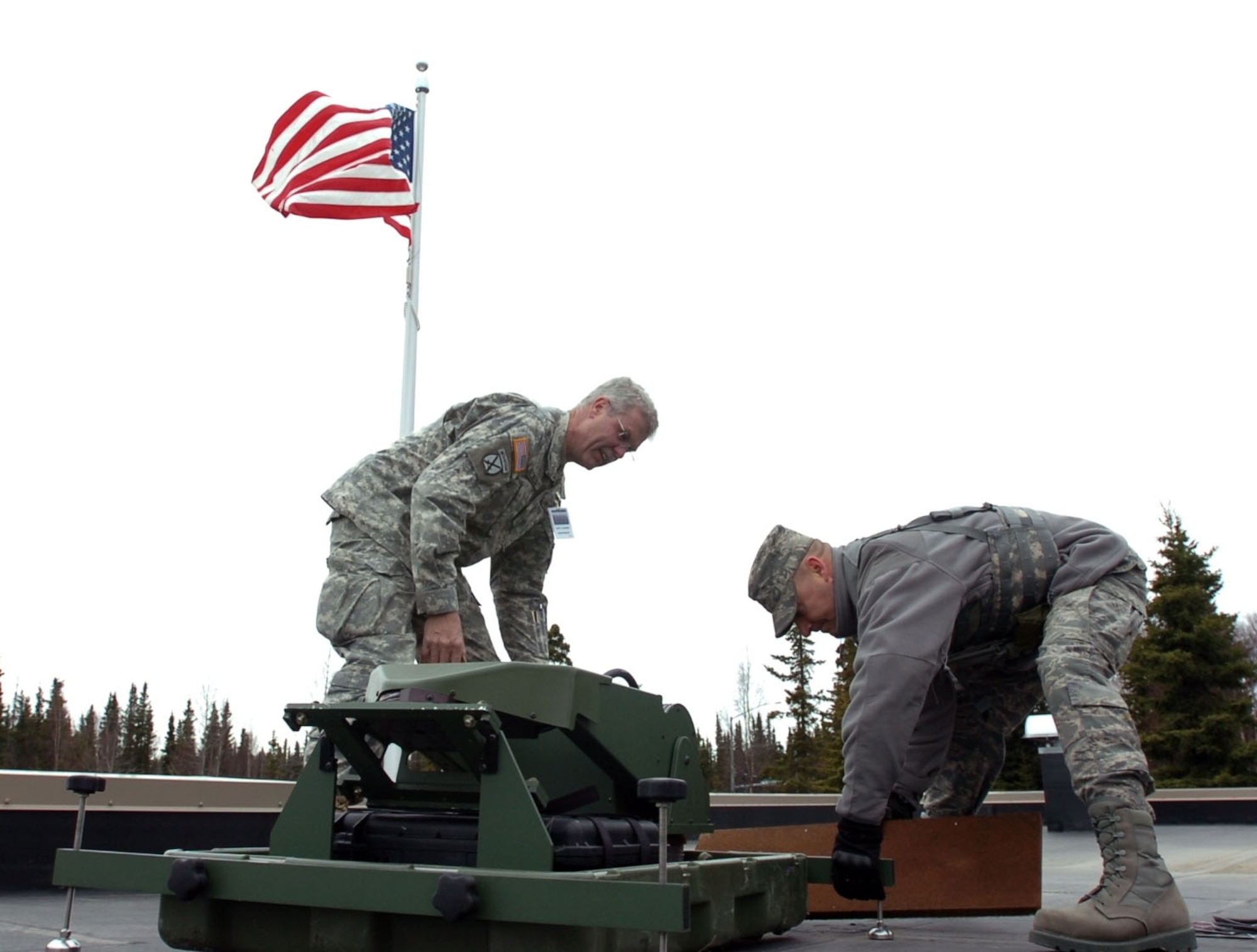 Army Master Sgt. Larry Wiedel, Joint Forces Headquarter-North Carolina communication specialist, and Air Force 1st Lt. Marcus Huneycutt, 263rd Combat Communications Squadron officer in charge, set up a satellite communication dish at the National Guard Armory in Kenai, Alaska, during the Alaska National Guard Vigilant Guard 2010 exercise April 25. Alaska NG VG-2010 is an exercise sponsored by the National Guard Bureau that allows Joint Forces Headquarters, Joint Task Forces and 