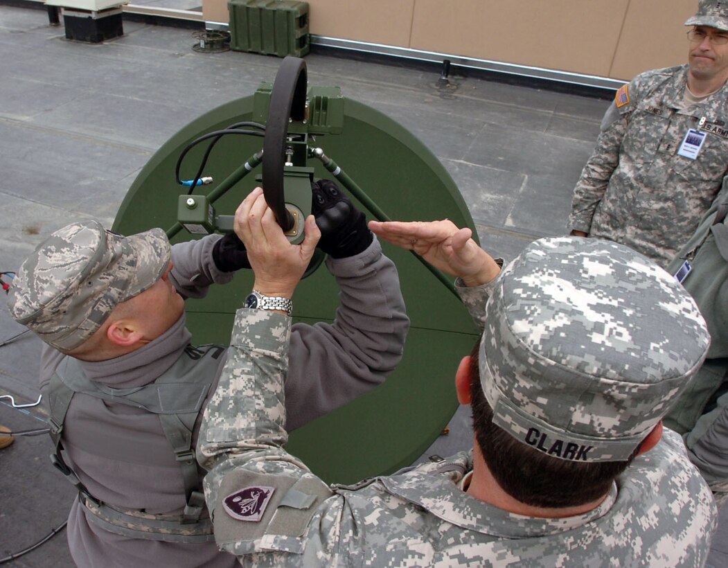 Air Force 1st Lt. Marcus Huneycutt, 263rd Combat Communication Squadron officer in charge, and Chief Warrant Officer 4 William Clark, an automation technician with the Computer Network Defense Team, Joint Forces Headquarters- North Carolina, set up a satellite communication dish on the National Guard Armory in Kenai, Alaska, during the Alaska National Guard’s Vigilant Guard 2010, April 25. Vigilant Guard is an exercise program sponsored by the National Guard Bureau that allows Joint Forces Headquarters, Joint Task Forces and various field units to improve command and control and to exercise operational relationships with local, state, regional and federal partners.  (NCNG Photo by Sgt. Zach Otto; Joint Task Force – Tarheel, North Carolina National Guard)