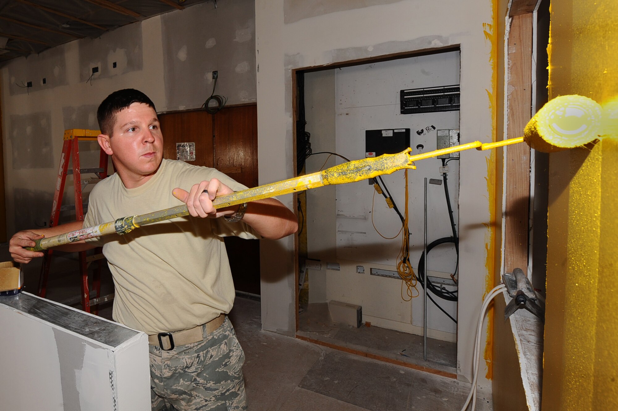 Staff Sgt. Lewis Wilder, 379th Expeditionary Civil Engineer Squadron structural craftsman, paints a wall as part of the Desert Eagle Lounge renovation project May 5, 2010. (U.S. Air Force photo by Senior Airman Kasey Zickmund)[RELEASED]