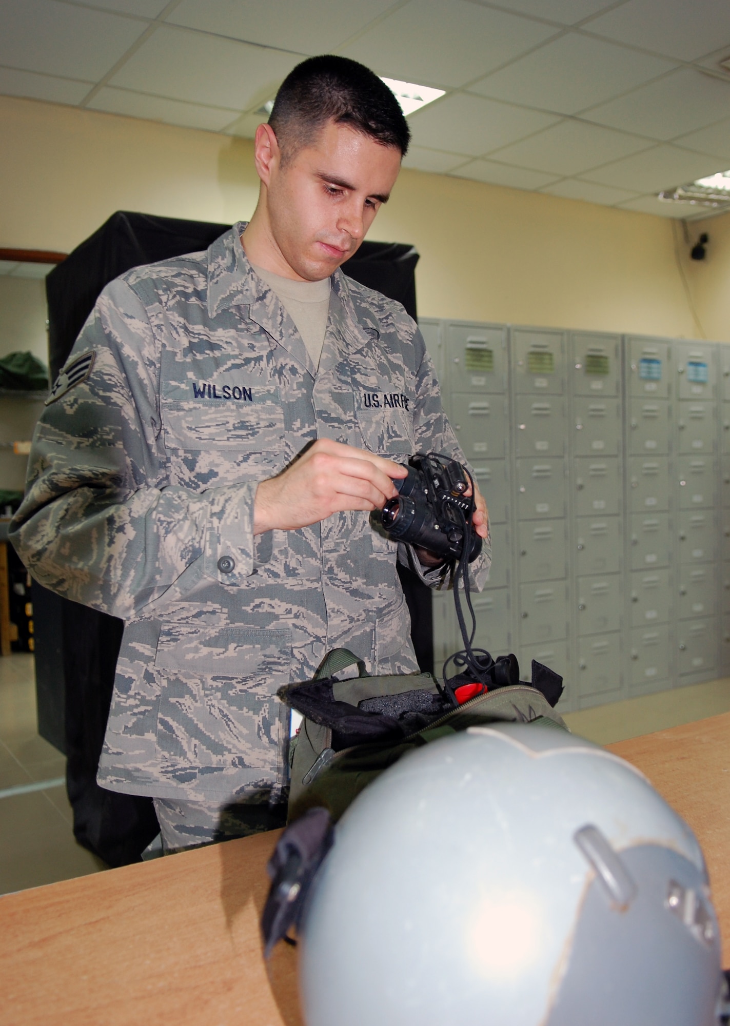U.S. Air Force Senior Airman Paul Wilson, 386th Operations Support Squadron Aircrew Flight Equipment specialist, inspects a piece of aircrew equipment March 23, 2010 at an air base in Southwest Asia. (U.S. Air Force photo by Staff Sgt. Lakisha A. Croley/Released)