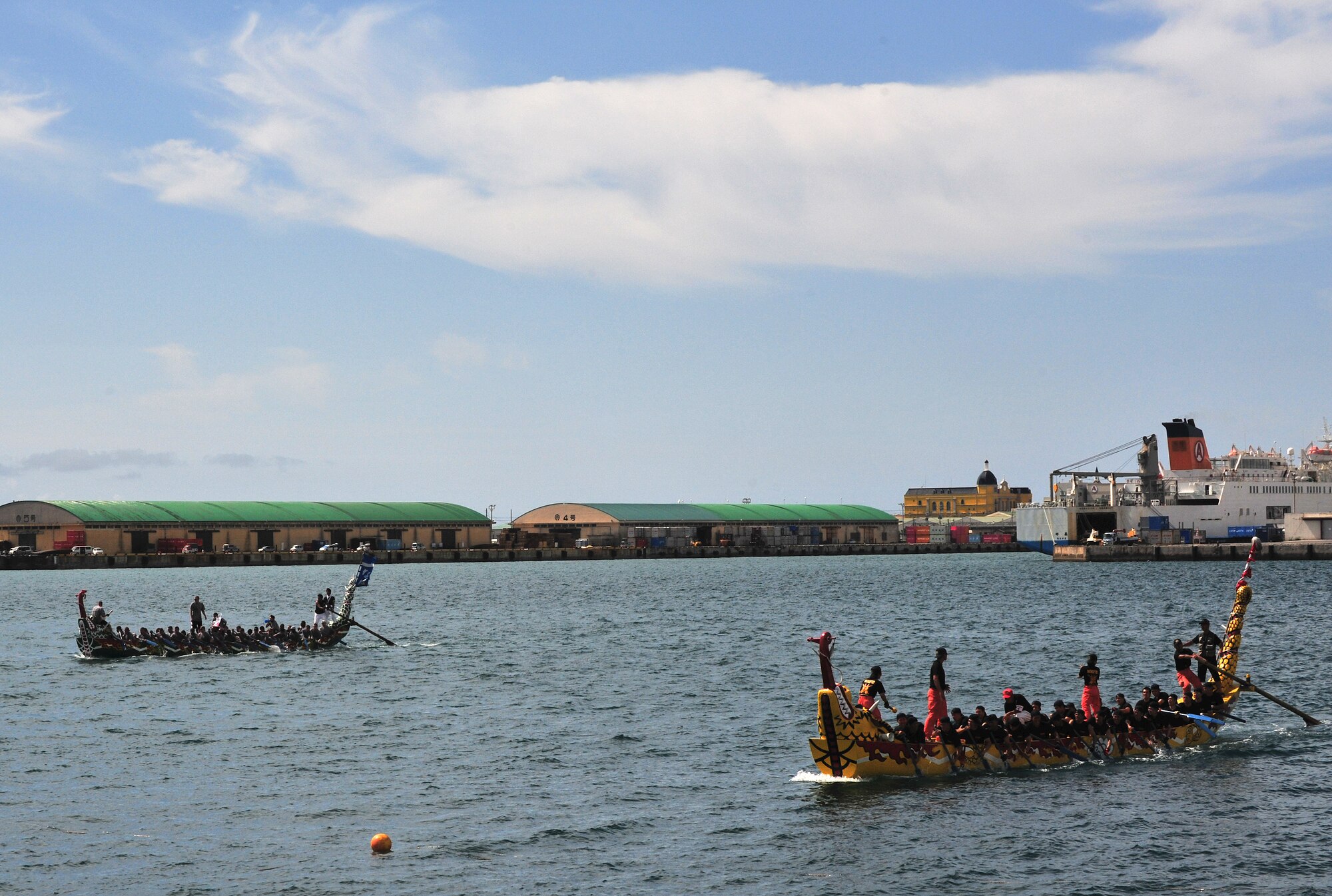 (Top) The Kadena Shoguns men's boat racing team finishes just 20 seconds behind the Naha City Fire Department team during the 36th Annual Naha Dragon Boat Races in Naha City May 5. The men's team came out on top with the fastest time of all U.S. military teams and finished second in their heat against the Naha Fire Department and U.S. Marine Corps teams. The Kadena women's team finished second in their heat against two local corporations, as well as second overall for U.S. military teams. (Air Force/Staff Sgt. Jason Lake)