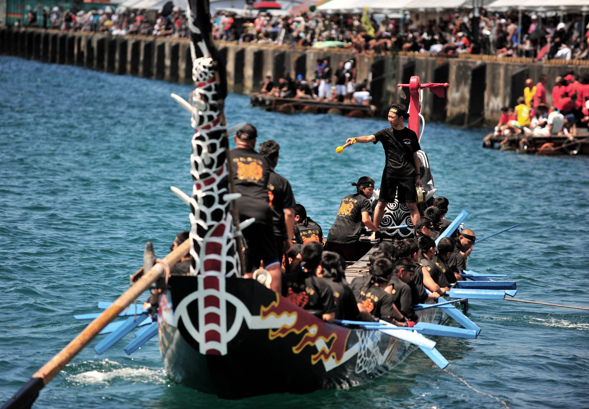 A local corporate team rows their way from the docks to the starting line during the 36th Annual Naha Dragon Boat Races in Naha City May 5. More than 50 teams comprised of firefighters, Japanese and American servicemembers and corporate workers participated in the event rooted in Chinese traditions that were adopted here in the 14th Century. Several cities host annual dragon boat races in Okinawa, but Naha's "haari" races are the largest on-island. (Air Force/Staff Sgt. Jason Lake)
