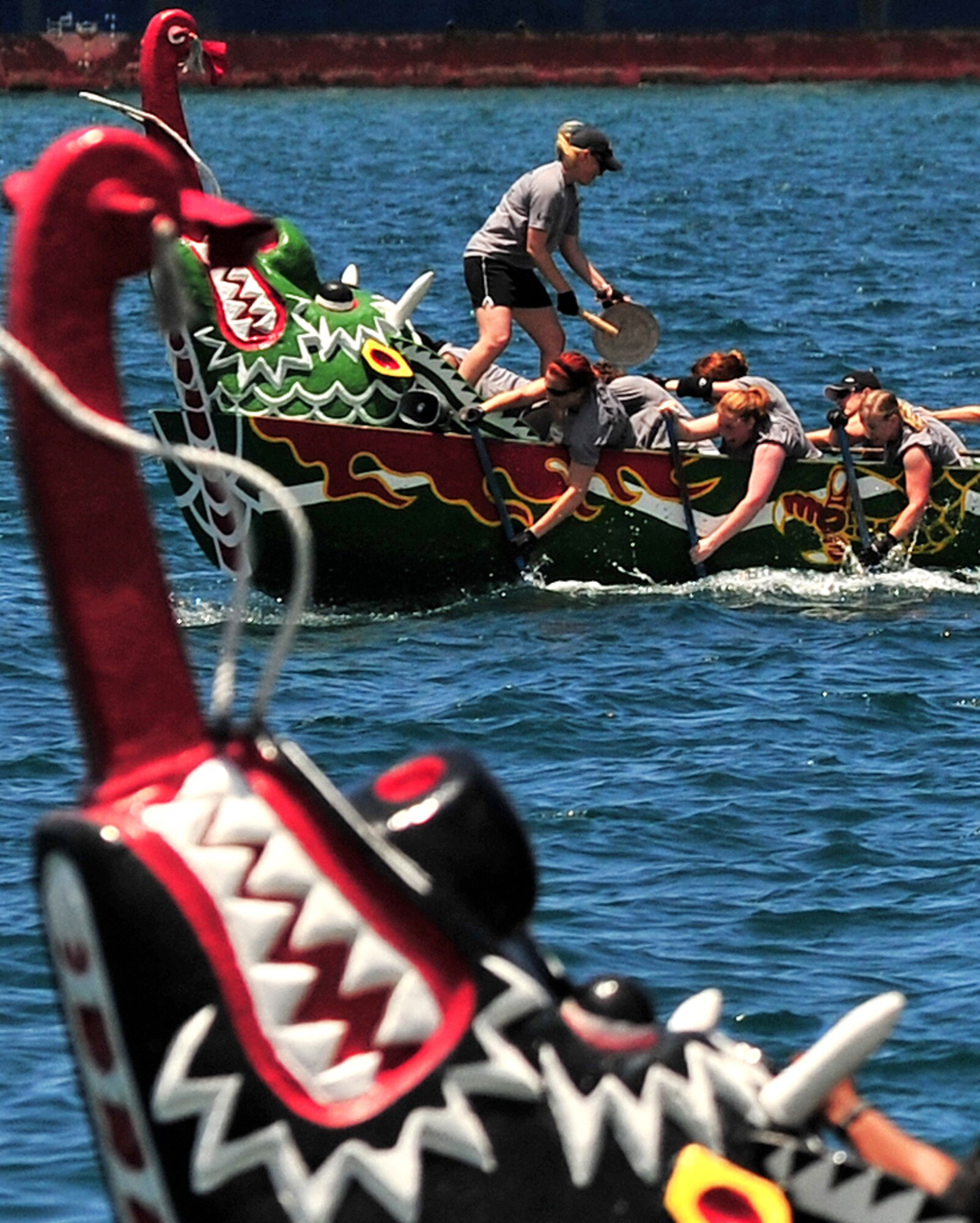 The Kadena Shoguns women's boat racing team try to catch up with a local Japanese corporate team in the final moments of their race during the 36th Annual Naha Dragon Boat Races in Naha City May 5. The Kadena women's team finished second in their heat against two local corporations, as well as second overall for U.S. military teams. The men's team came out on top with the fastest time of all U.S. military teams and finished second in a close heat against the Naha Fire Department and U.S. Marine Corps teams. (Air Force/Staff Sgt. Jason Lake)