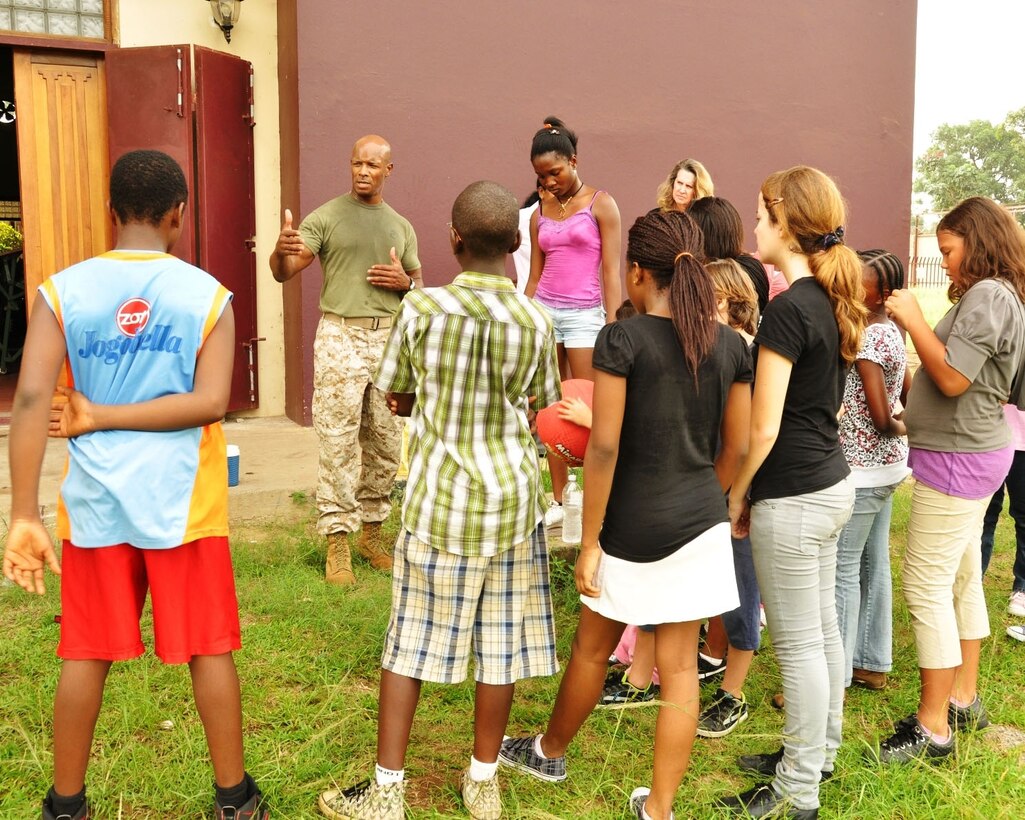 Marine Corps Staff Sgt. Gary Morris talks to students at the American International School in Monrovia, Liberia, where he has been voluntarily teaching a physical education class since February 2010. U.S. Africa Command photo by Nicole Dalrymple
