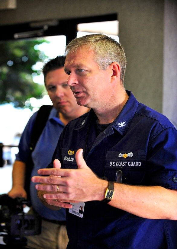 U.S. Coast Guard Incident Response Commander, Captain Steven Poulin briefs the media on the status of the Deepwater Horizon oil spill prior to a media support flight aboard a HC-144 helicopter, Mobile, Alabama, May 6, 2010.