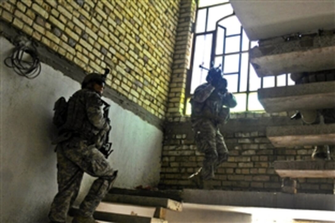 U.S. soldiers move upstairs to clear a house in Biritz in Diyala province, Iraq, May 3, 2010. The Iraqi police planned and executed the mission to show citizens a continued presence within the community. The soldiers are assigned to the 2nd Infantry Division's Company B, 5th Battalion, 20th Infantry Regiment, 3rd Stryker Brigade Combat Team.