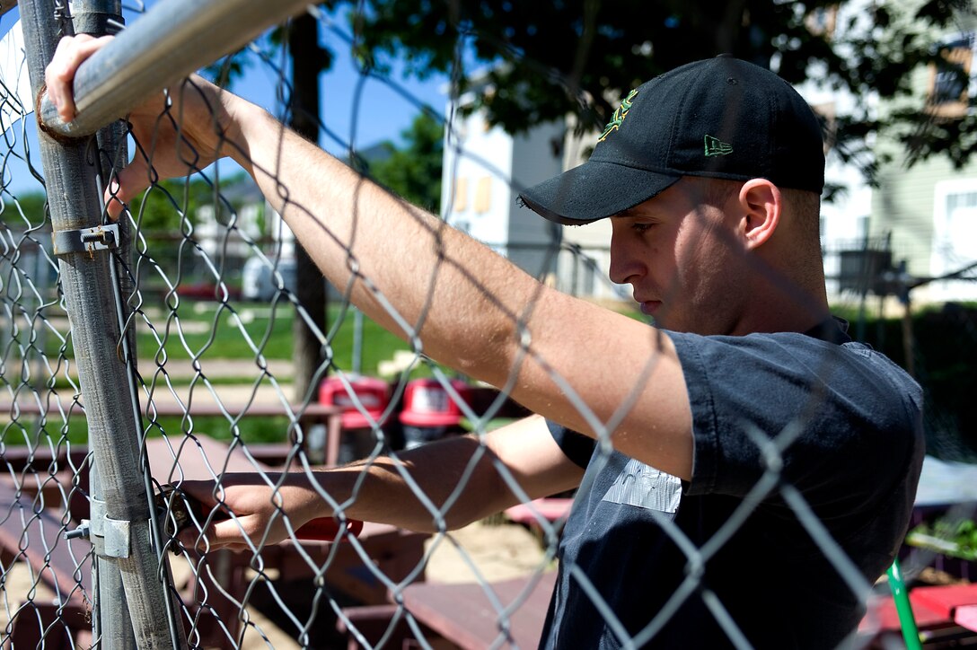 Cpl. Chris, an office clerk with Guard Company, Marine Barracks Washington, constructs a fenced off an area for Habitat for Humanity volunteers to eat, May 7.  Marines from MBW volunteered their time with Habitat for Humanity to construct affordable housing for families in the local community.  (Photo by Lance Cpl. Jeremy Ware)