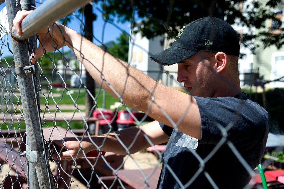 Cpl. Chris, an office clerk with Guard Company, Marine Barracks Washington, constructs a fenced off an area for Habitat for Humanity volunteers to eat, May 7.  Marines from MBW volunteered their time with Habitat for Humanity to construct affordable housing for families in the local community.  (Photo by Lance Cpl. Jeremy Ware)