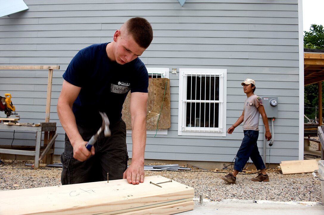 Pfc. Patrick Gabriel, a fiscal clerk, Marine Barracks Washington, constructs a window frame for a Habitat for Humanity house, May 7.  Marines from MBW volunteered their time with Habitat for Humanity to construct affordable housing for families in the local community.  (Photo by Lance Cpl. Jeremy Ware)