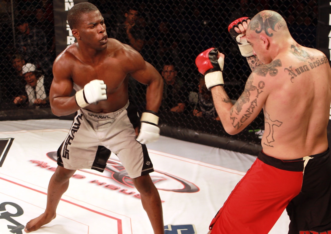 Mix Marshal Artist Darren Smith (left), aims in on his opponent, Carlos Sapao Ban, during the MMA Cage Fight Night at Camp Pendleton’s 11 Area field, May 7. The Marine Corps Community Services sponsored event, featured 18 competitors from PureCombat and Hitman Fights organizations, and was free for all base residents. The fight night included 9 brawls, with the final bout being a competition for the PureCombat championship belt.