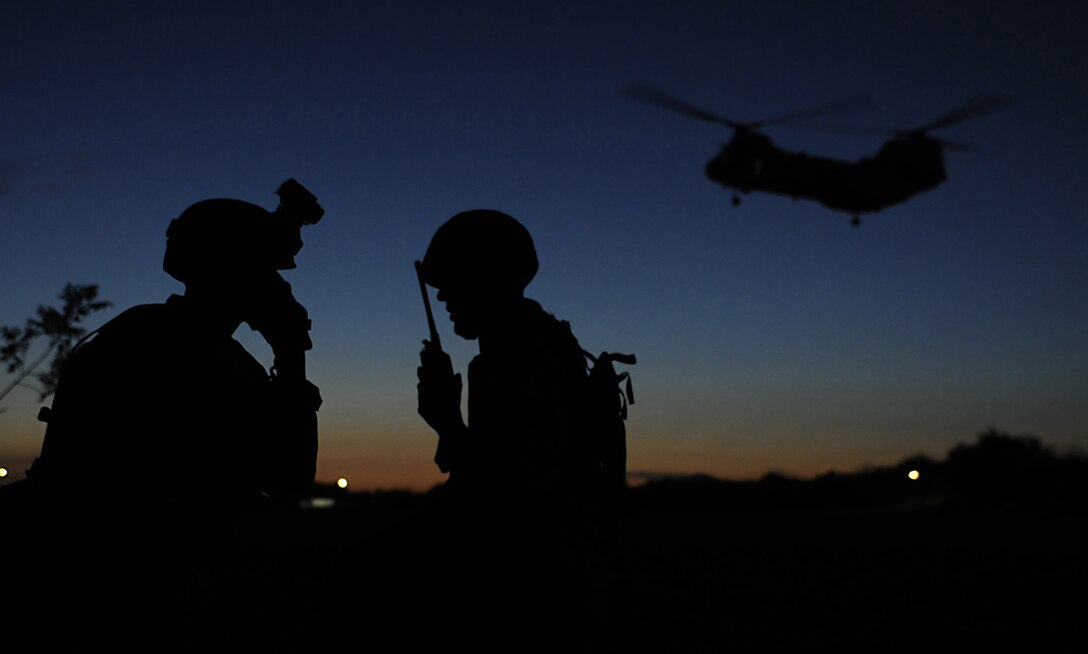 Lance Cpl. Keaton L. Lyon, left, and 2nd Lt. Douglas A. Columbus monitor radios while a Marine Corps CH-46 Sea Knight helicopter approaches a landing zone during a noncombatant evacuation operation exercise at the West Wetlands Park in Yuma, Ariz., on May 7, 2010. The exercise is part of the current Weapons and Tactics Instructor course being held at the Marine Corps Air Station in Yuma. The city of Yuma regularly allows the Marines to hold exercises within its parks, which adds realism for the students. Since the Korean War, the Marine Corps has conducted at least 16 noncombatant evacuations, the most recent in Lebanon in 2006. Many of the pilots involved were trained in Yuma, said Col. Gary Thomas, commanding officer of Marine Aviation Weapons and Tactics Squadron 1, which teaches the course. Columbus, a 23-year-old native of Hawthorn Woods, Ill., and a section commander with 2nd Low-Altitude Air Defense Battalion based in Cherry Point, N.C., was a student in the course. Lyon, a 19-year-old native of Tonopah, Ariz., serves as a radio operator with 1st Battalion, 1st Marine Regiment, based at Camp Pendleton in California.