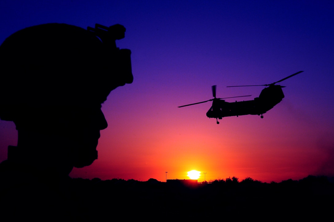 Pfc. Philip Cox, Combat Logistics Battalion 13 water support technician, watches a CH-46 Sea Knight helicopter take off from West Wetlands Park in Yuma, Ariz., during a noncombatant evacuation operation exercise May 7, 2010. The exercise is part of the Weapons and Tactics Instructor course and takes place in the city of Yuma to provide Marines a realistic urban setting. WTI is hosted semiannually by Marine Aviation Weapons and Tactics Squadron 1.