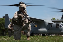 Cpl. Andrew Fields, a Terre Haute, Ind., native and an assaultman with Company K, 3rd Battalion, 24th Marine Regiment, helps provide security around a MV-22 Osprey landing site during a Marine Air-Ground Task Force demonstration at Joe Moakley Park in South Boston May 7, 2010. The exercise was a practice run for a full demonstration May 8 at Carson Beach during Marine Week Boston.