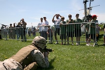 A infantryman from Company K, 3rd Battalion, 24th Marine Regiment, 4th Marine Division, provides ground security after offloading an MV-22B Osprey with Marine Medium Tiltrotor Squadron 264 during a Marine Air-Ground Task Force demonstration, at Moakley Park in Boston, Mass., May 7, 2010. Marines demonstrated how a MAGTF works as part of Marine Week to help increase the public awareness of the Marine Corps' way of life.