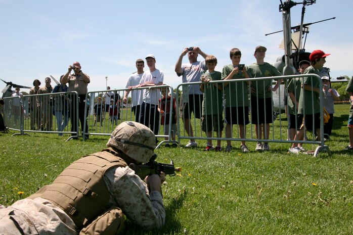 A infantryman from Company K, 3rd Battalion, 24th Marine Regiment, 4th Marine Division, provides ground security after offloading an MV-22B Osprey with Marine Medium Tiltrotor Squadron 264 during a Marine Air-Ground Task Force demonstration, at Moakley Park in Boston, Mass., May 7, 2010. Marines demonstrated how a MAGTF works as part of Marine Week to help increase the public awareness of the Marine Corps' way of life.
