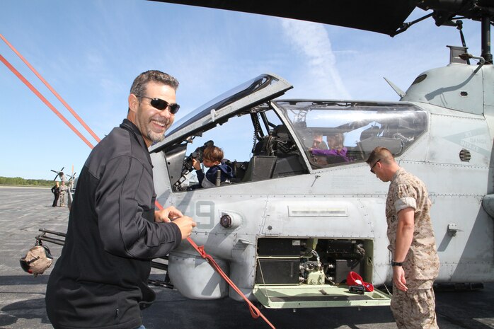 Mike Lowell, third baseman for the Boston Red Sox, and his children enjoy a static display before taking flight in an MV-22 Osprey, May 7, 2010.  Lowell and his teammate, Jocoby Ellsbury, outfielder, visited the base to show their appreciation to the Marines and take a tour of Boston from the sky.  More than 900 Marines descended on Boston for Marine Week, May 3-9, to share the Corps' culture, history and traditions with Bostonians.