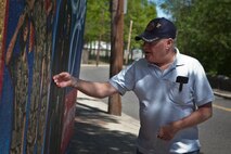 Norman Weinrehe, a West Roxbury, Mass., resident admires the Marine Corps mural in Hyde Park May 7, 2010. Creating the mural for Bostonians was a joint effort with combat camera Marines from around the Corps and the Mayor's mural crew. Planning for the mural began months in advance and Marines stated painting at the park only two weeks ago. Weinrehe, a former Marine, said it's been a welcomed addition to his wife's and his afternoon walks.   ::r::::n::