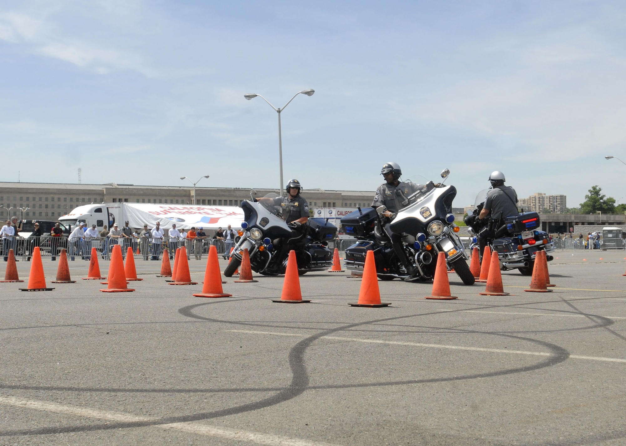 Pentagon Police perform a riding skill demonstration during the Pentagon Motorcycle Safety Event, May 7, 2010, in the Pentagon North Parking lot.  The event is to help enhance motorcyle safety awareness for new, old and non riders.  (Defense Department photo/Petty Officer 1st Class Molly A. Burgess)